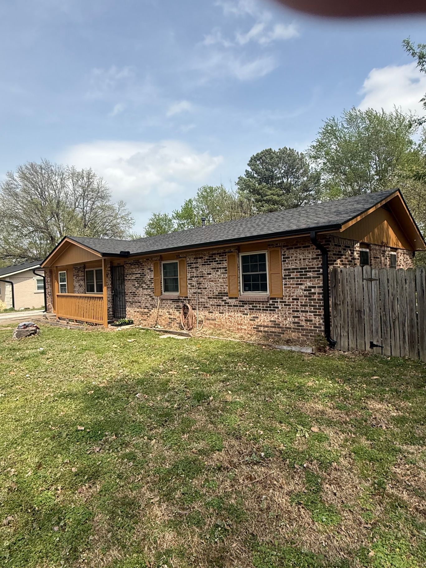 Brick ranch home in Northwest Arkansas with black seamless gutters and downspout